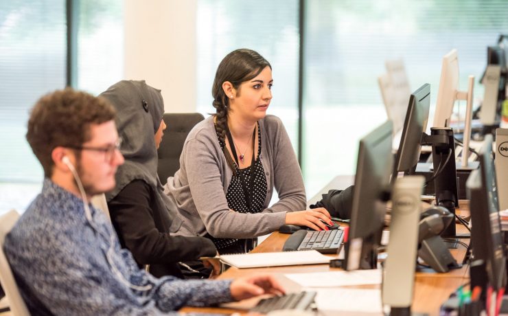 unknown persons using computer indoors